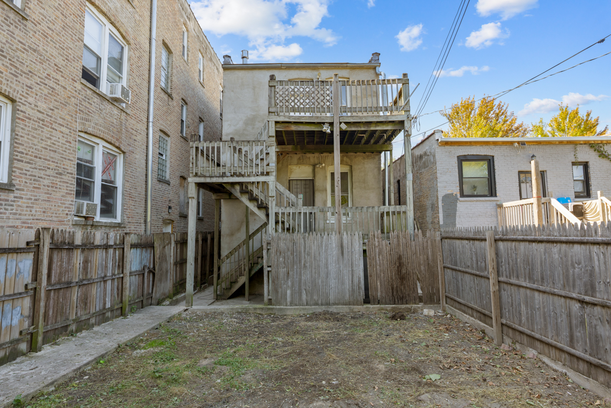 1141 South St Louis Avenue Chicago, IL 60624 - Photo 24 of 26 a view of a house with wooden fence