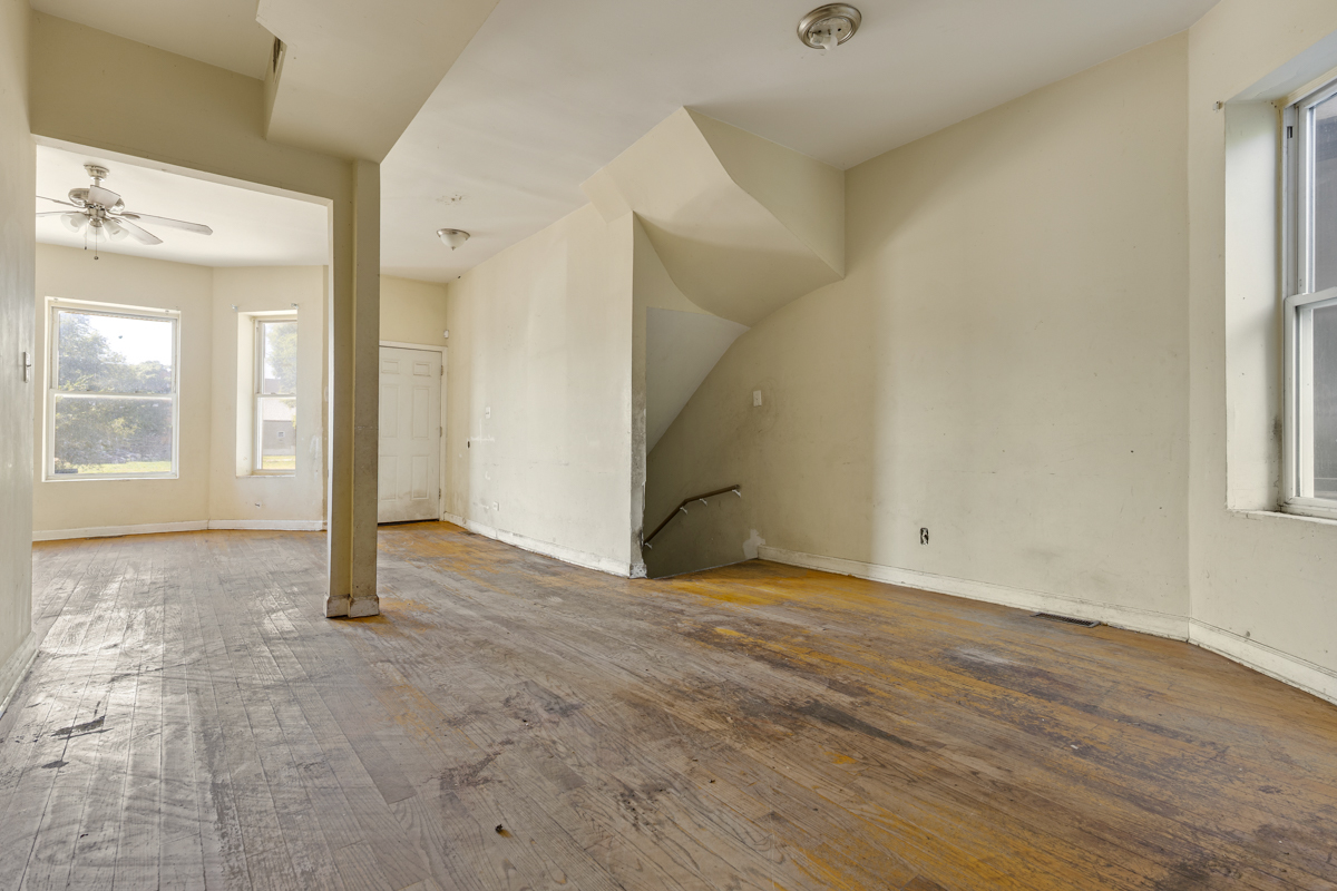 1141 South St Louis Avenue Chicago, IL 60624 - Photo 5 of 26 a view of an empty room with wooden floor and a window