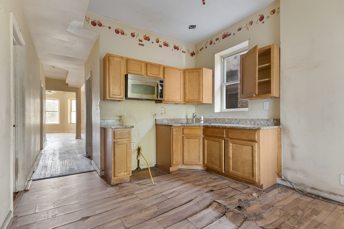 1141 South St Louis Avenue Chicago, IL 60624 - Photo 7 of 26 a kitchen with granite countertop a stove a sink and a granite counter top