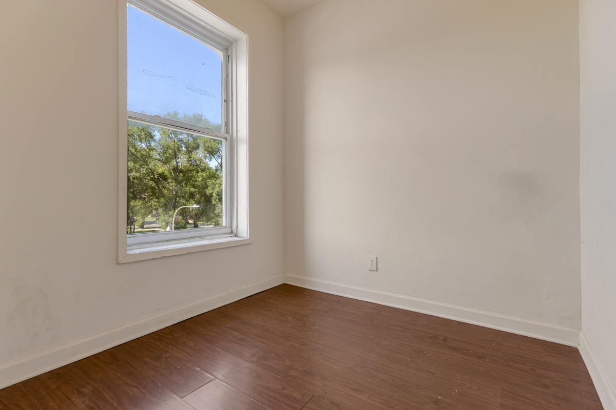 1141 South St Louis Avenue Chicago, IL 60624 - Photo 10 of 26 an empty room with wooden floor and windows