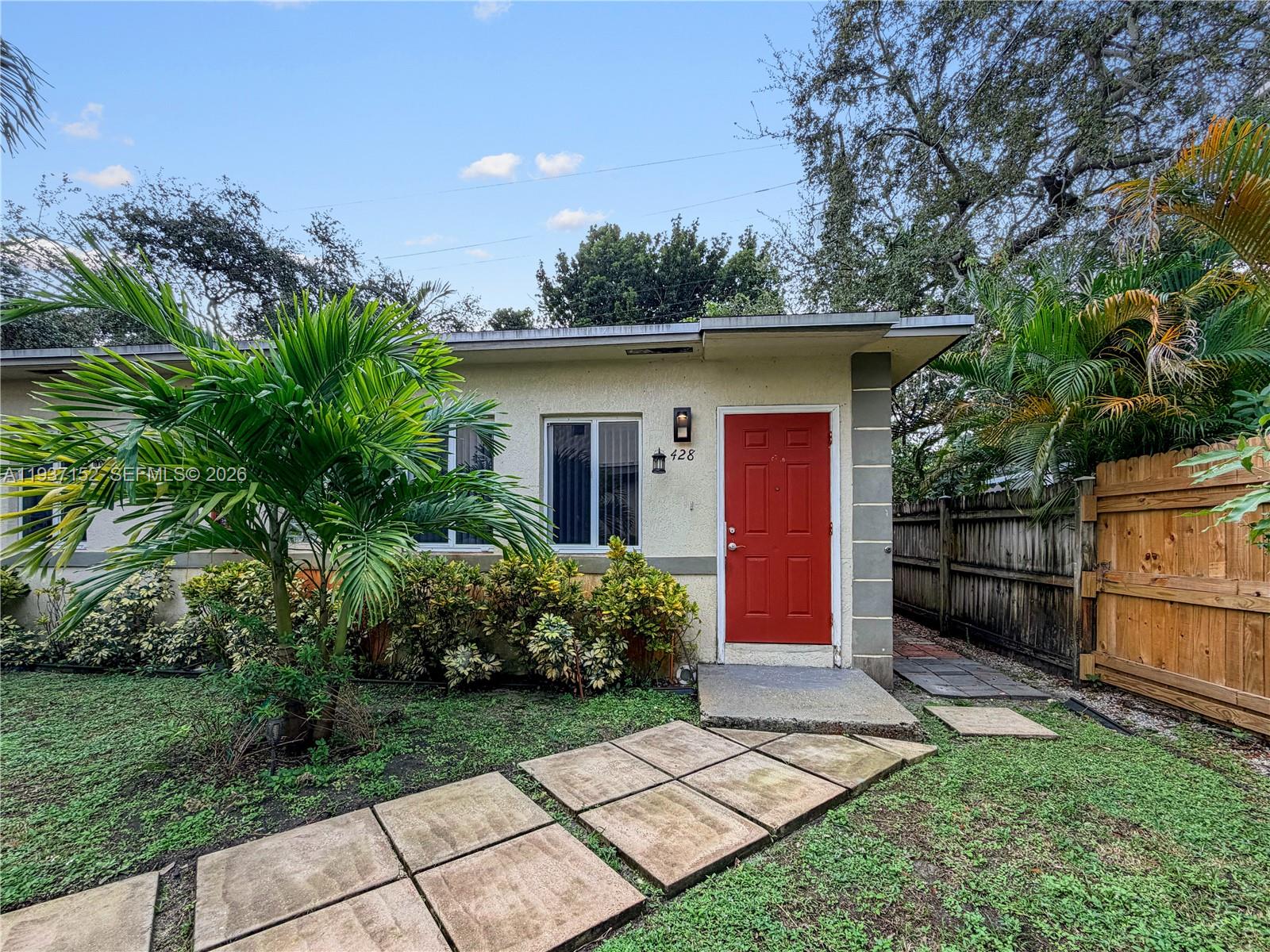 426 Northeast 77th Street, Unit 428 Miami, FL 33138 - Photo 1 of 22 a view of a house with a yard