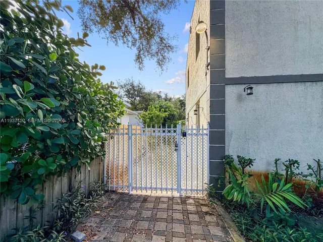 a view of a pathway of a house with a small yard