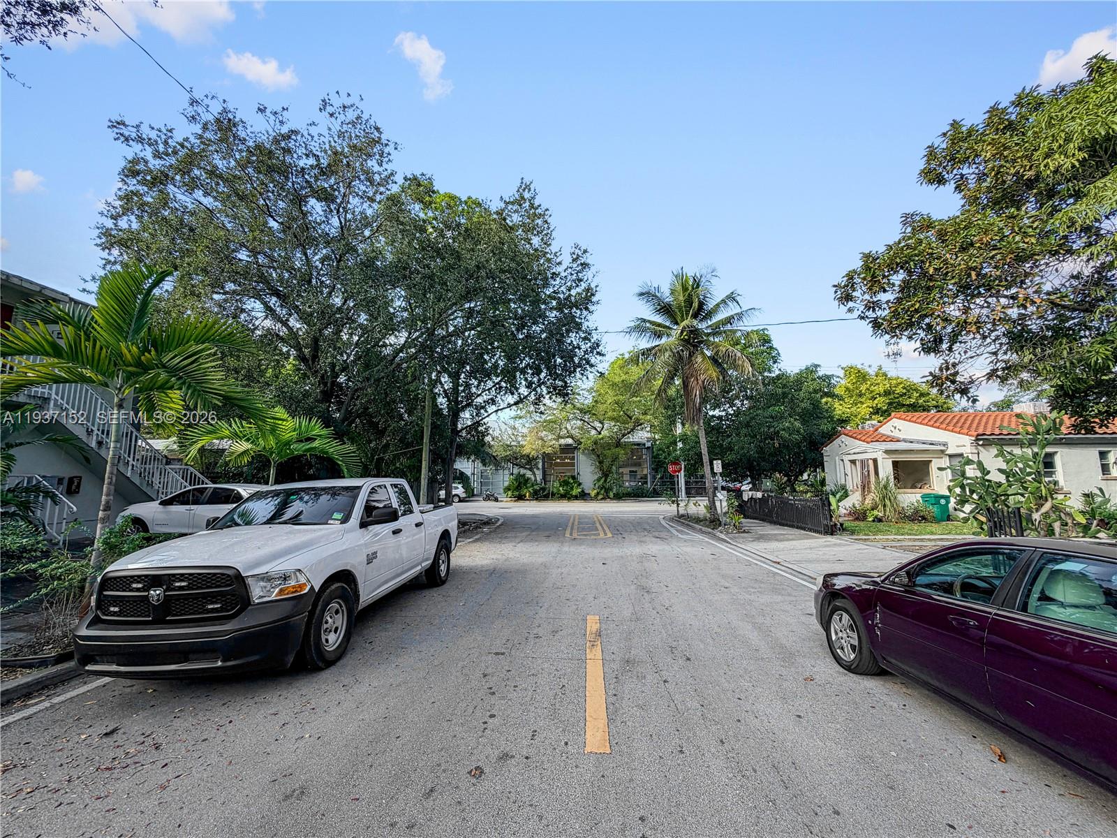 426 Northeast 77th Street, Unit 428 Miami, FL 33138 - Photo 20 of 22 a view of a street with cars parked on the road