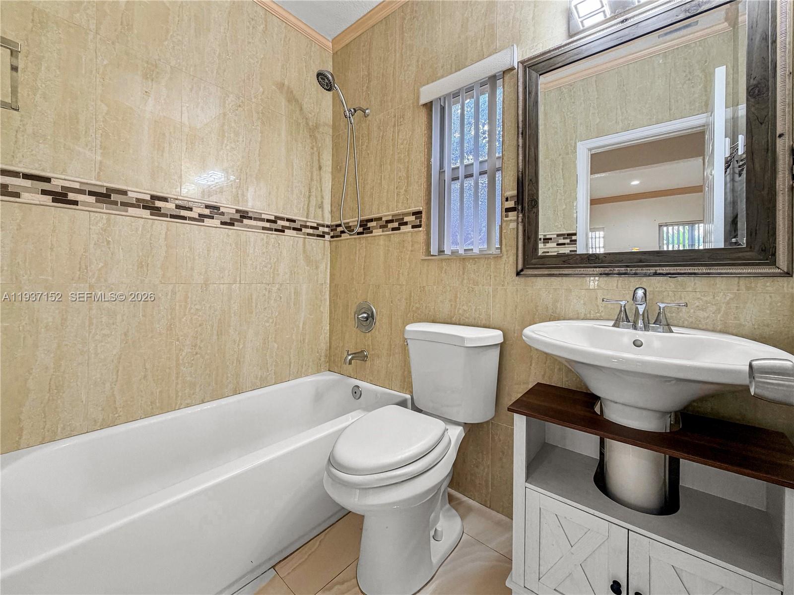 426 Northeast 77th Street, Unit 428 Miami, FL 33138 - Photo 6 of 22 a bathroom with a sink toilet a mirror and shower