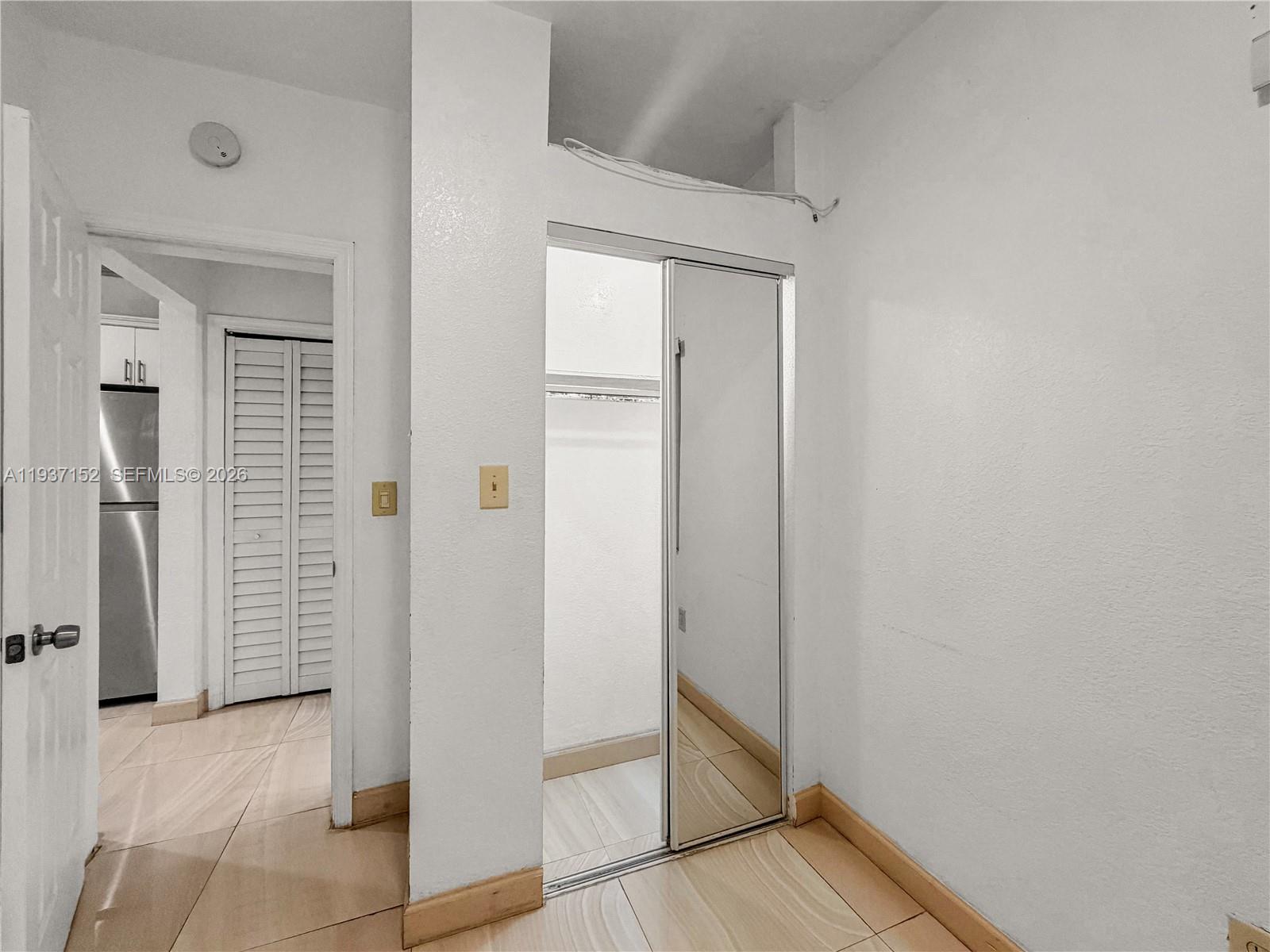 426 Northeast 77th Street, Unit 428 Miami, FL 33138 - Photo 10 of 22 a view of an entryway with wooden floor