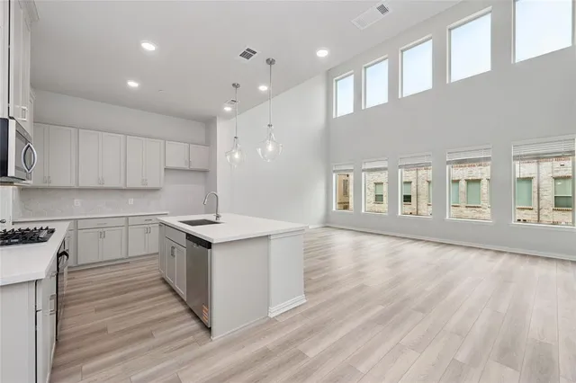 a kitchen with stainless steel appliances granite countertop a stove and a sink