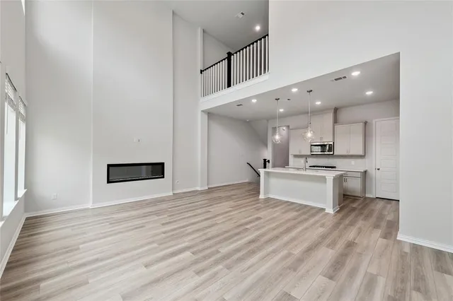 a view of kitchen with refrigerator microwave and stove