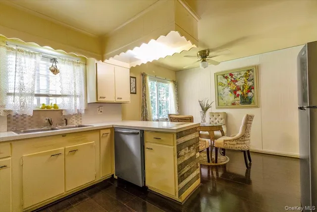 a view of a kitchen with a sink cabinets and wooden floor