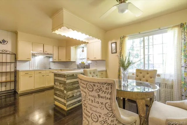 a large kitchen with kitchen island a stove a sink a dining table and chairs