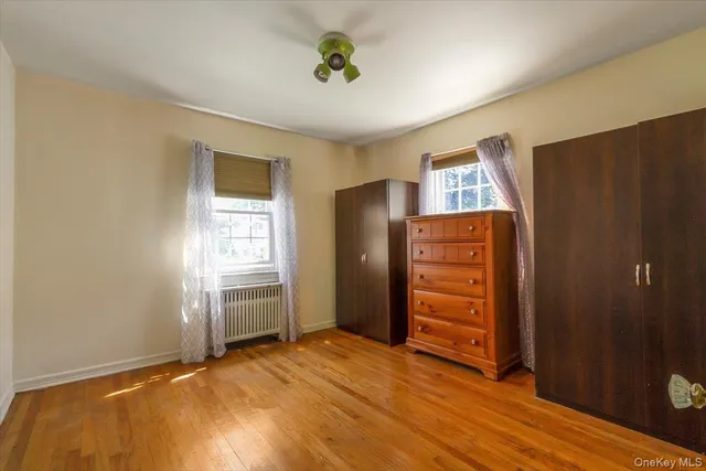 a view of an empty room with closet and window