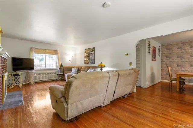 a living room with furniture flat screen tv and a fireplace