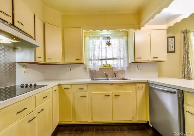 a kitchen with stainless steel appliances granite countertop a sink a stove and cabinets