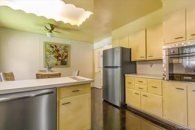 a kitchen with stainless steel appliances a refrigerator sink and stove