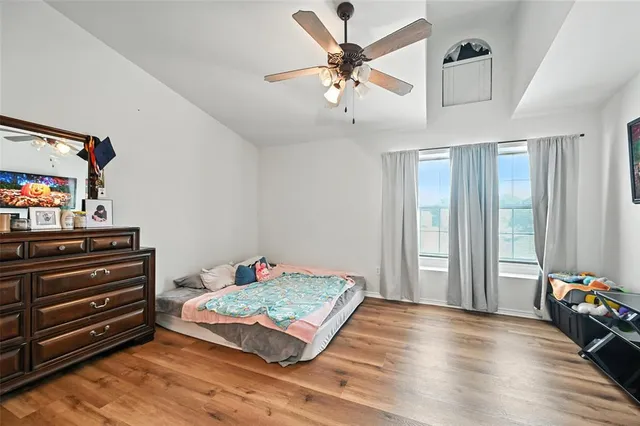 a bedroom with a bed and wooden floor