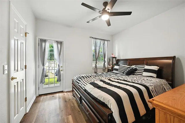 a bedroom with bed and wooden floor