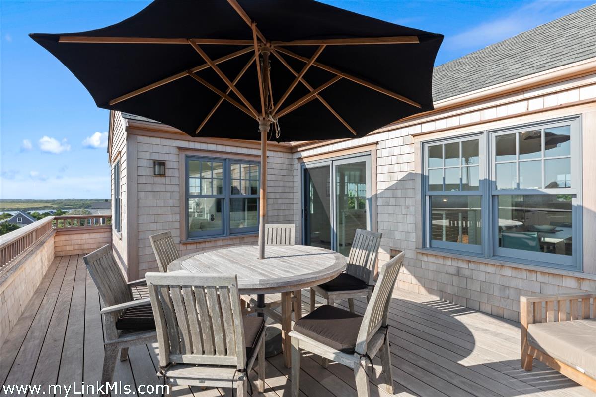 3 Tautemo Way Nantucket, MA 02554 - Photo 18 of 57 a view of a roof deck with table and chairs