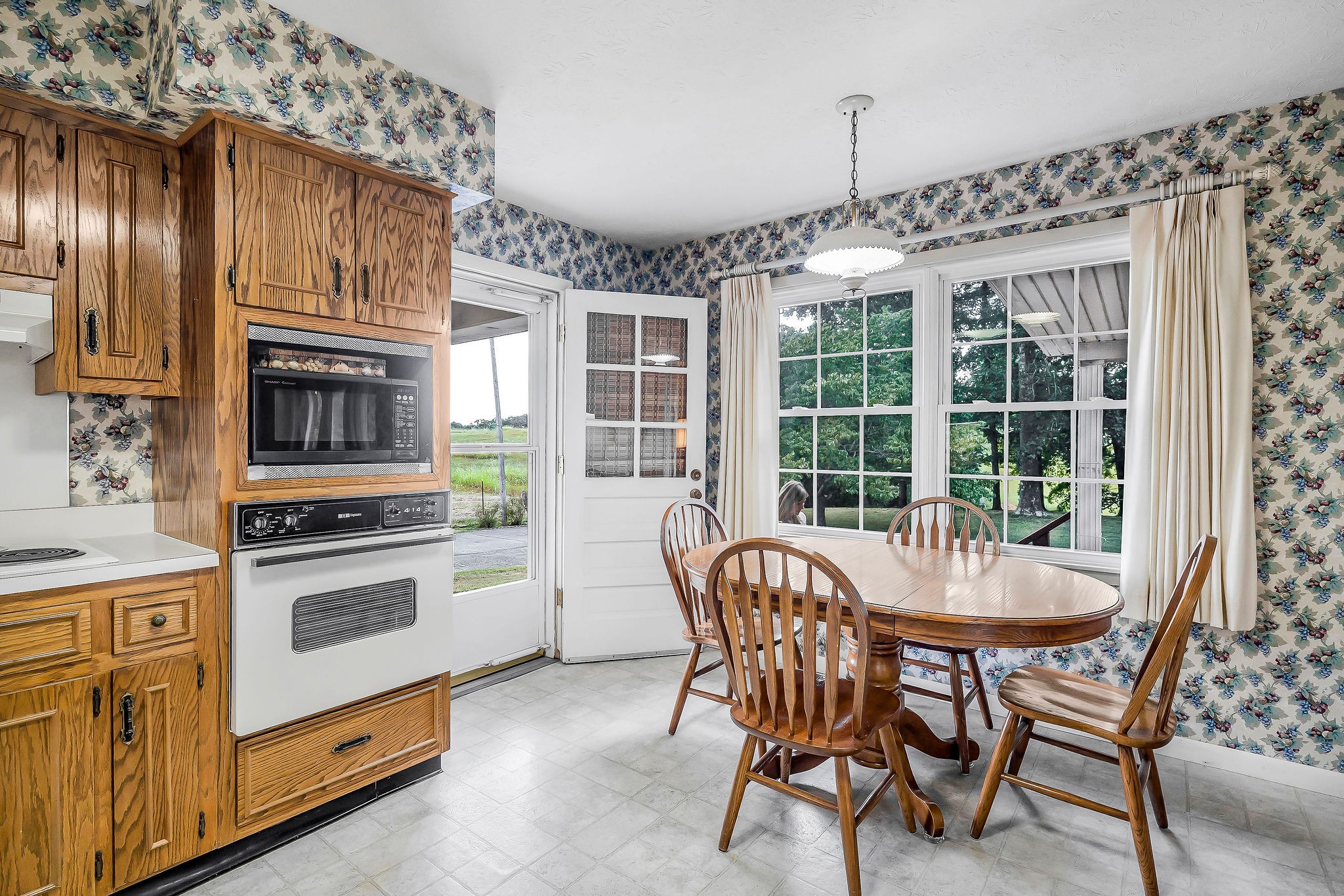 5036 Pendergrass Road Byrdstown, TN 38549 - Photo 20 of 38 a dining room with furniture a chandelier and fireplace