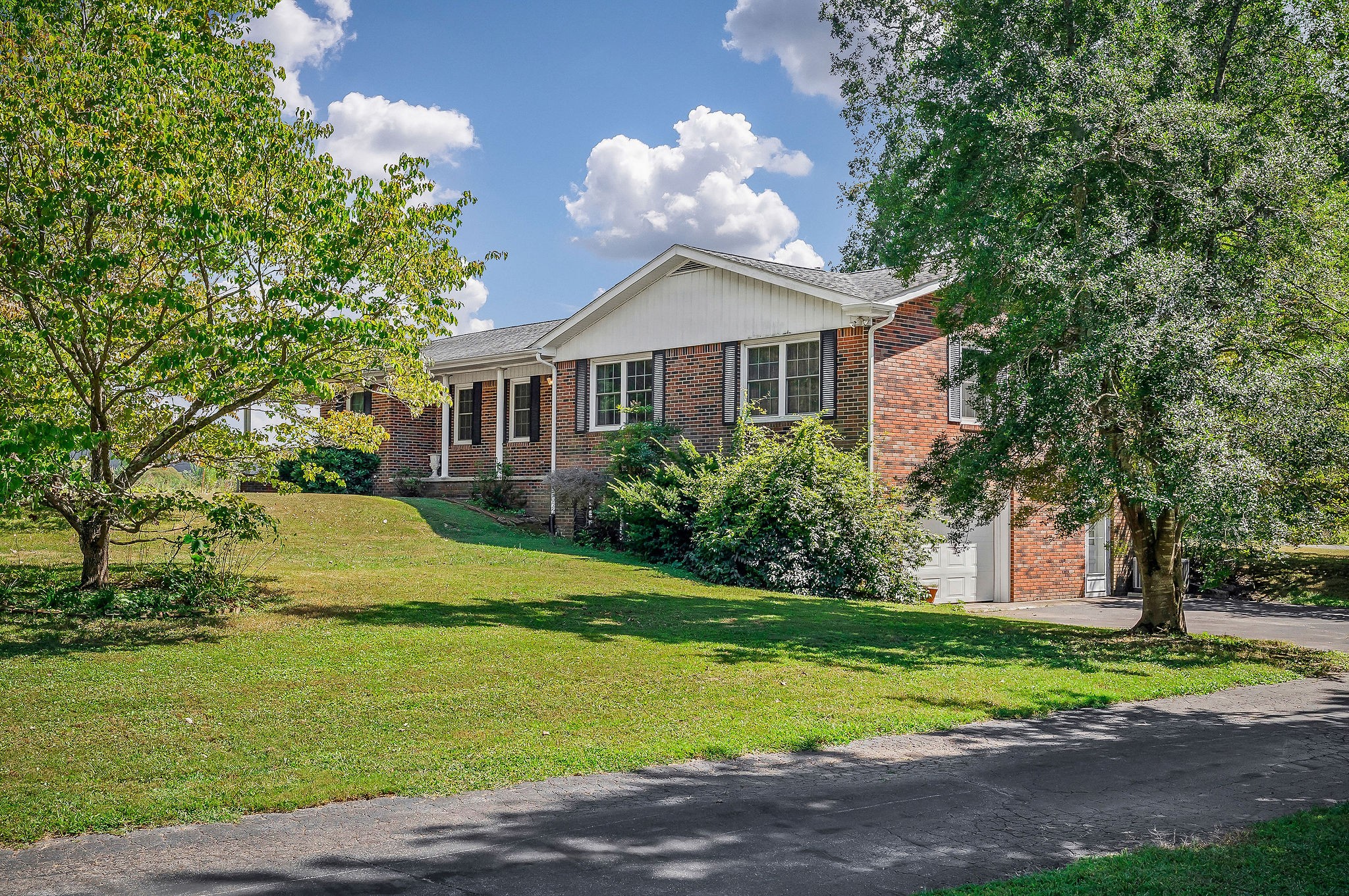 5036 Pendergrass Road Byrdstown, TN 38549 - Photo 2 of 38 a front view of a house with a garden and trees