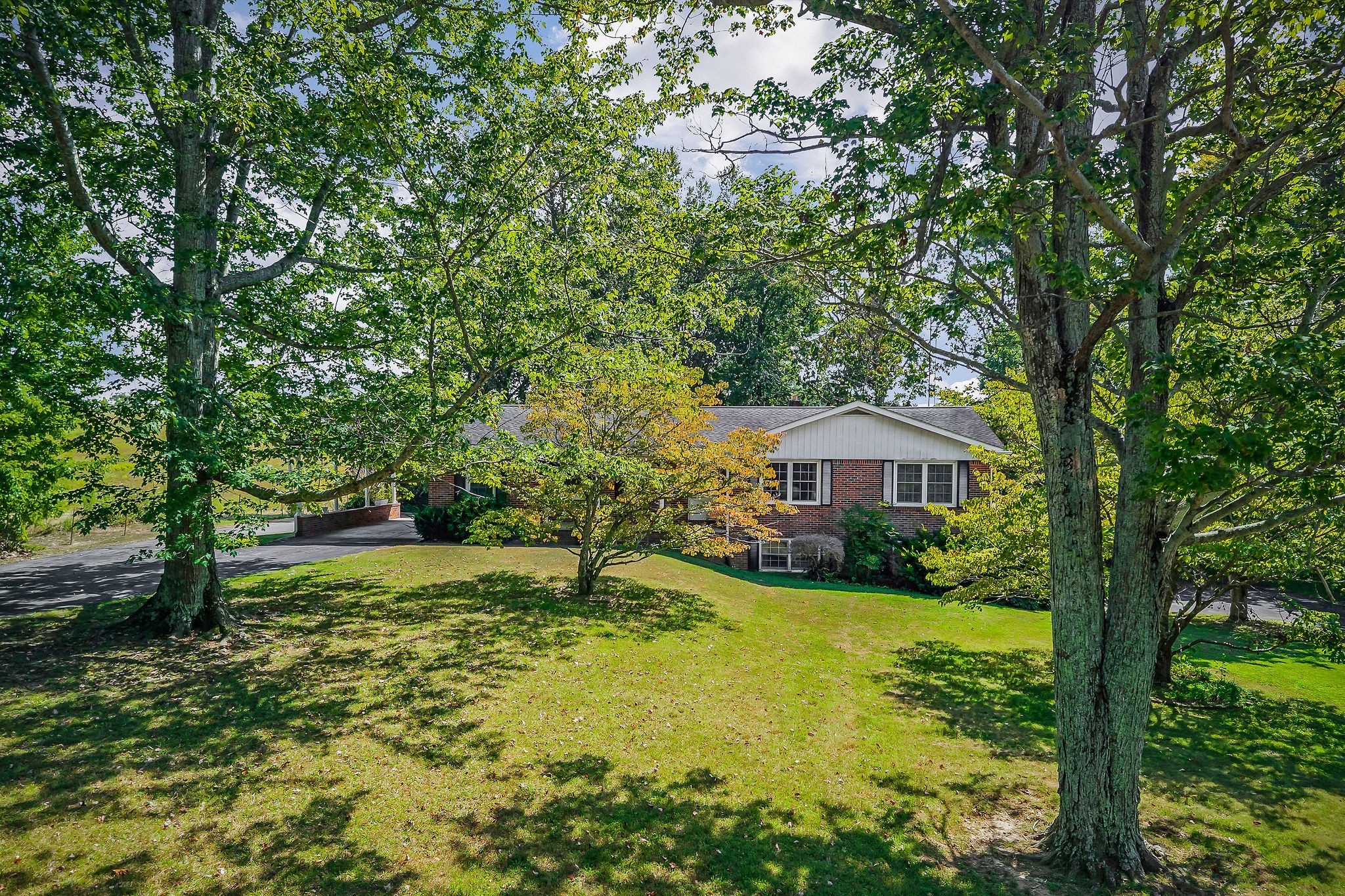 5036 Pendergrass Road Byrdstown, TN 38549 - Photo 25 of 38 a view of a garden with a house in the background