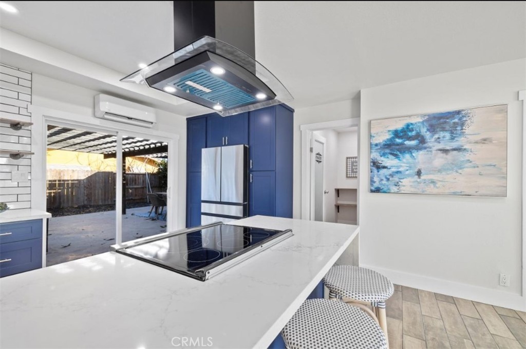 19472 Catfish Circle Huntington Beach, CA 92646 - Photo 23 of 30 a kitchen with stainless steel appliances a dining table and chairs