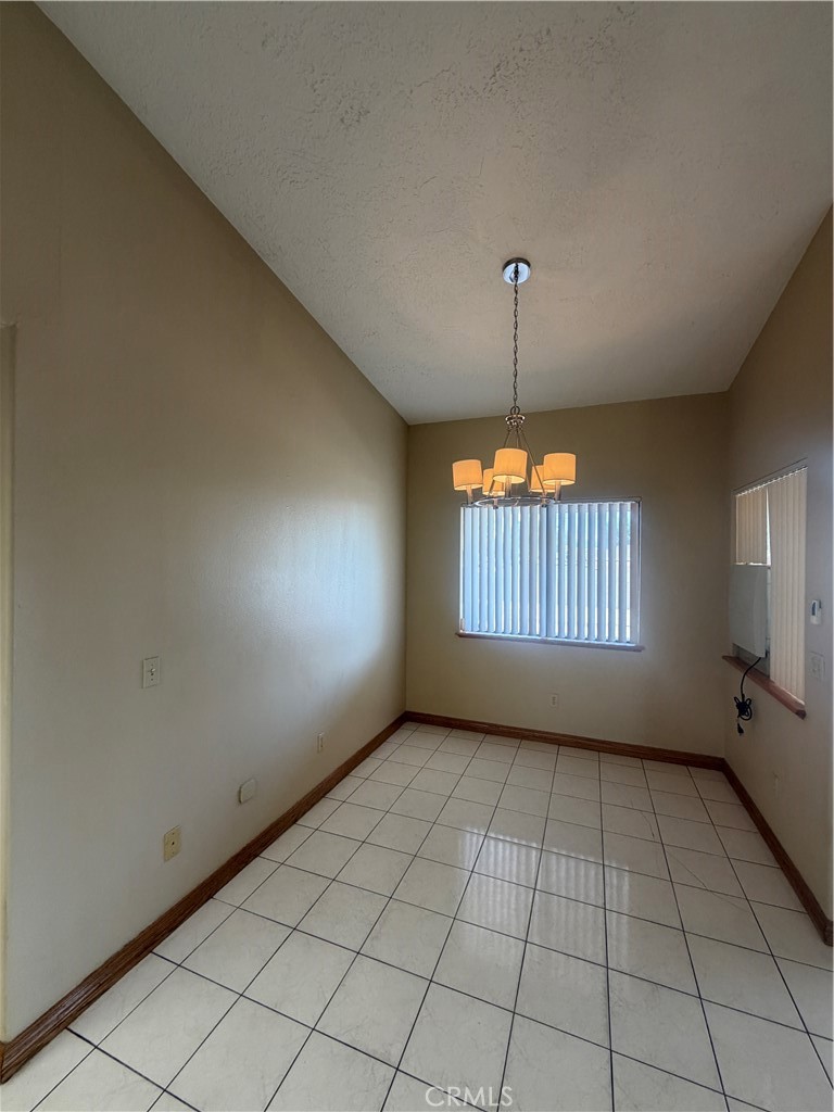 19609 Seneca Road Apple Valley, CA 92307 - Photo 15 of 37 an empty room with windows and fan