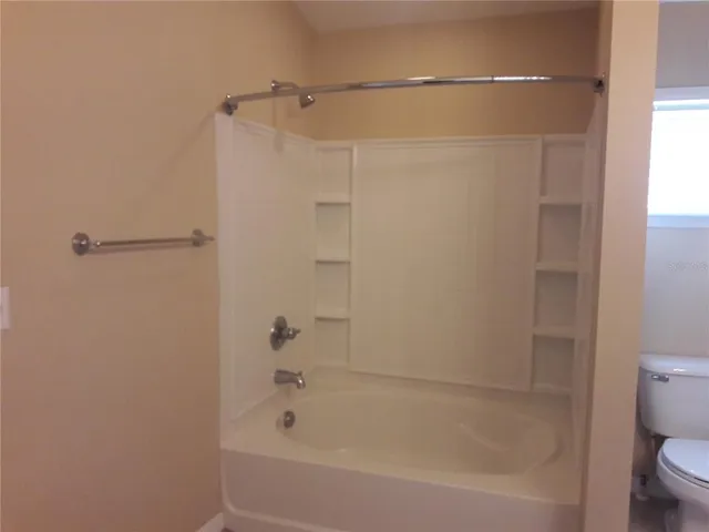 a bathroom with a bathtub and a toilet