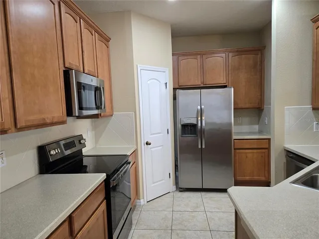 a kitchen with a refrigerator sink and microwave