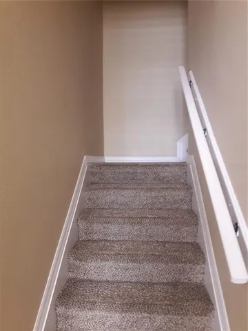 a view of staircase with white walls