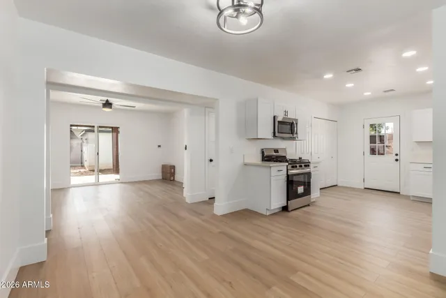 a view of a kitchen with a sink and a stove top oven