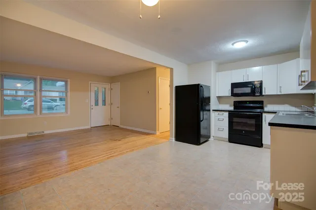 a kitchen with stainless steel appliances a refrigerator and a stove top oven