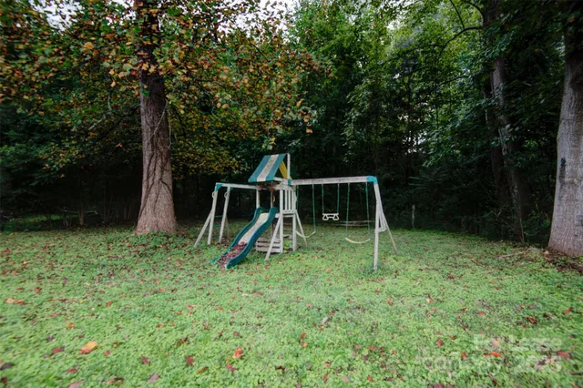 a backyard of a house with entertaining space and trampoline