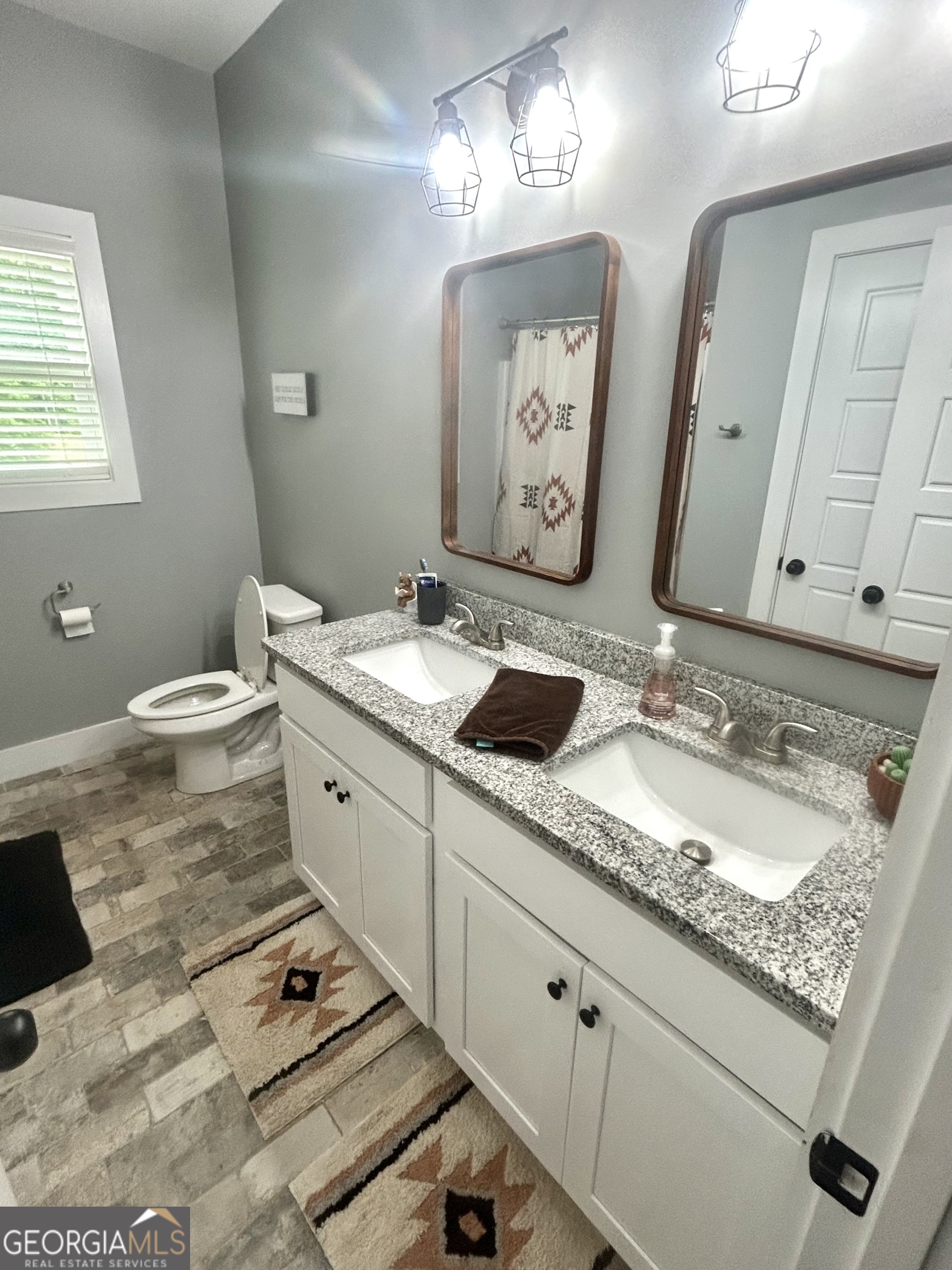 1250 Godfrey Road Madison, GA 30650 - Photo 30 of 42 a spacious bathroom with double vanity and a mirror