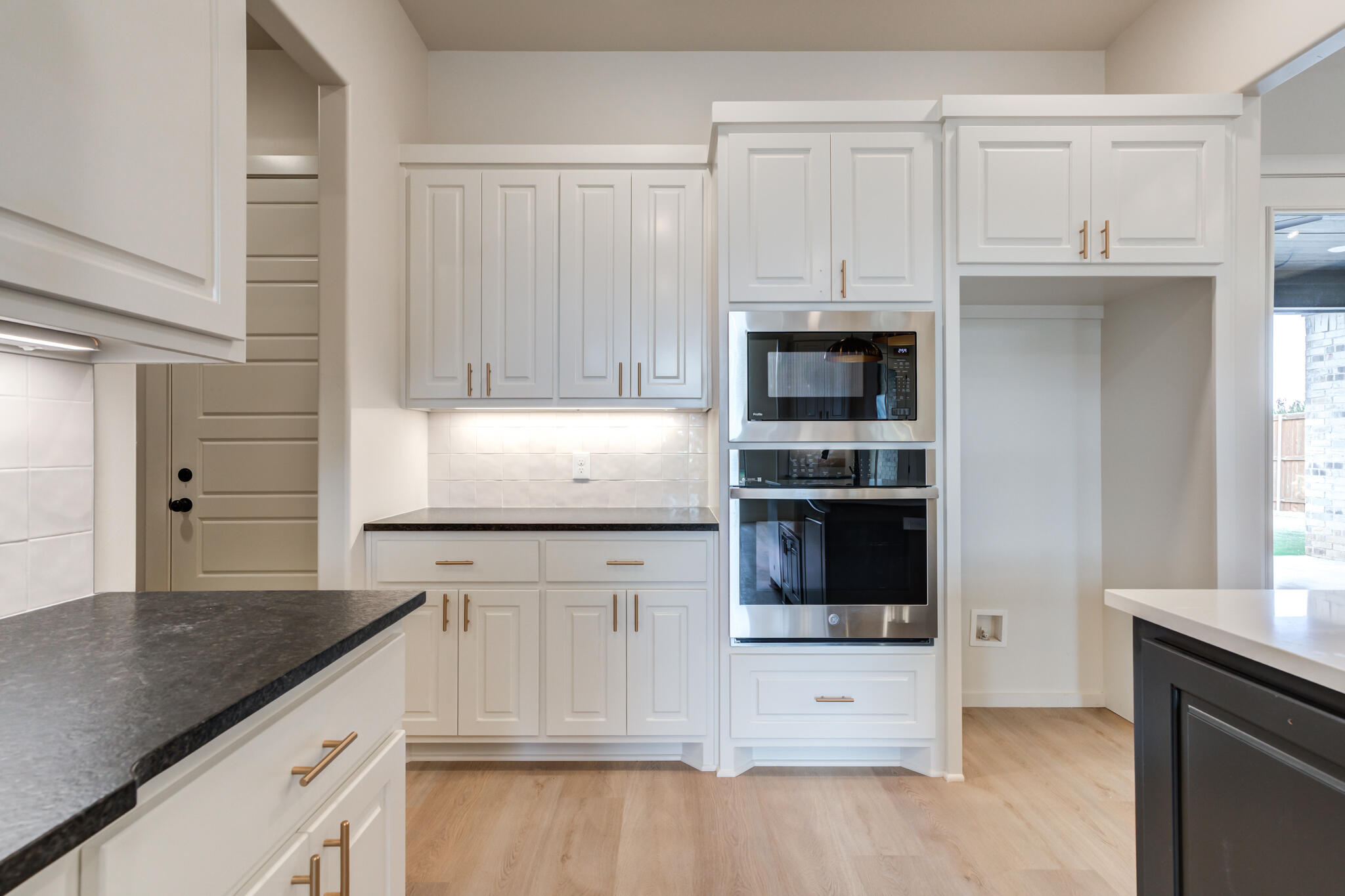 3516 141st Street Lubbock, TX 79423 - Photo 11 of 56 a kitchen with granite countertop white cabinets and stainless steel appliances