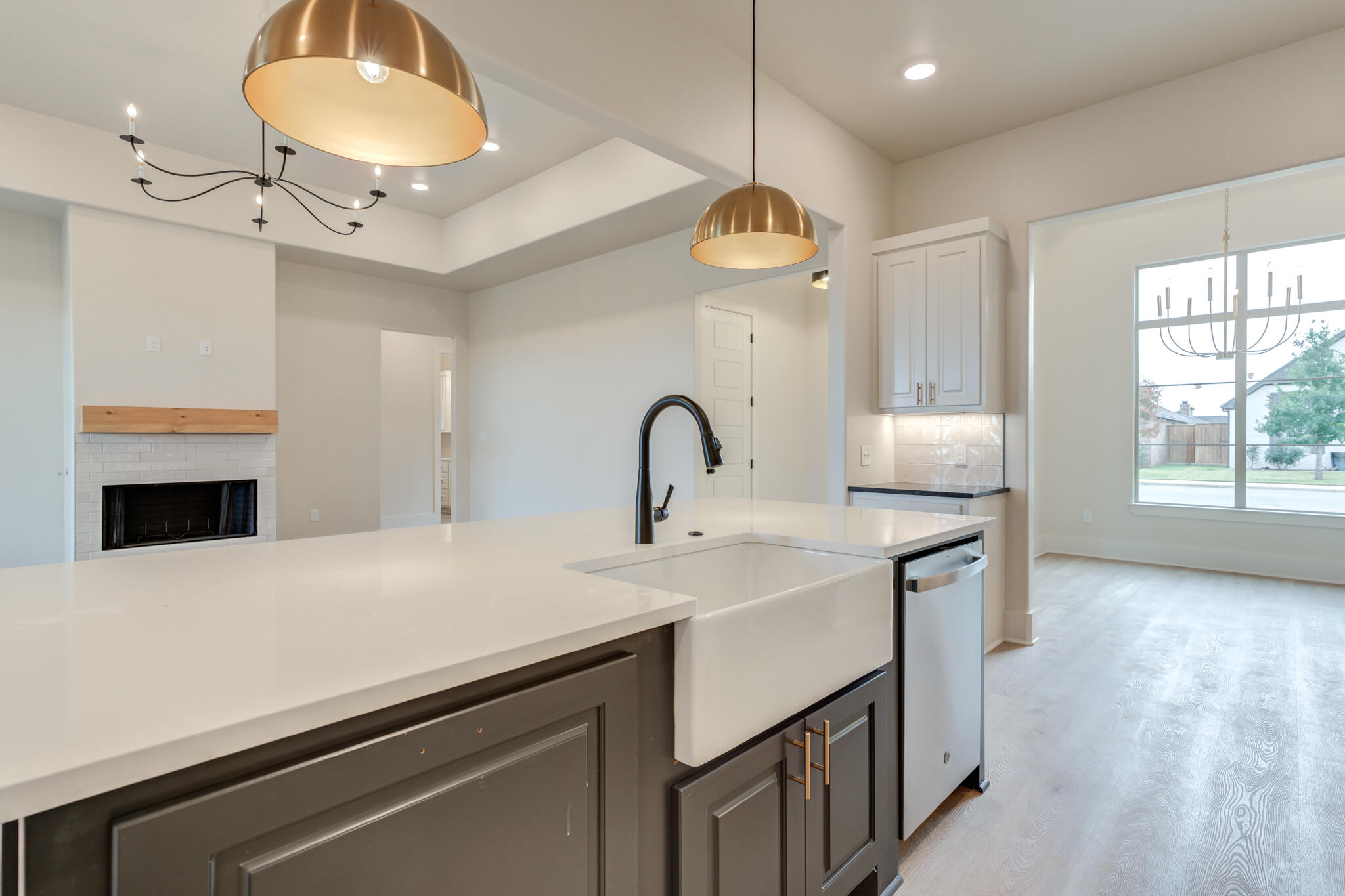 3516 141st Street Lubbock, TX 79423 - Photo 13 of 56 a kitchen with a sink a chandelier and living room view