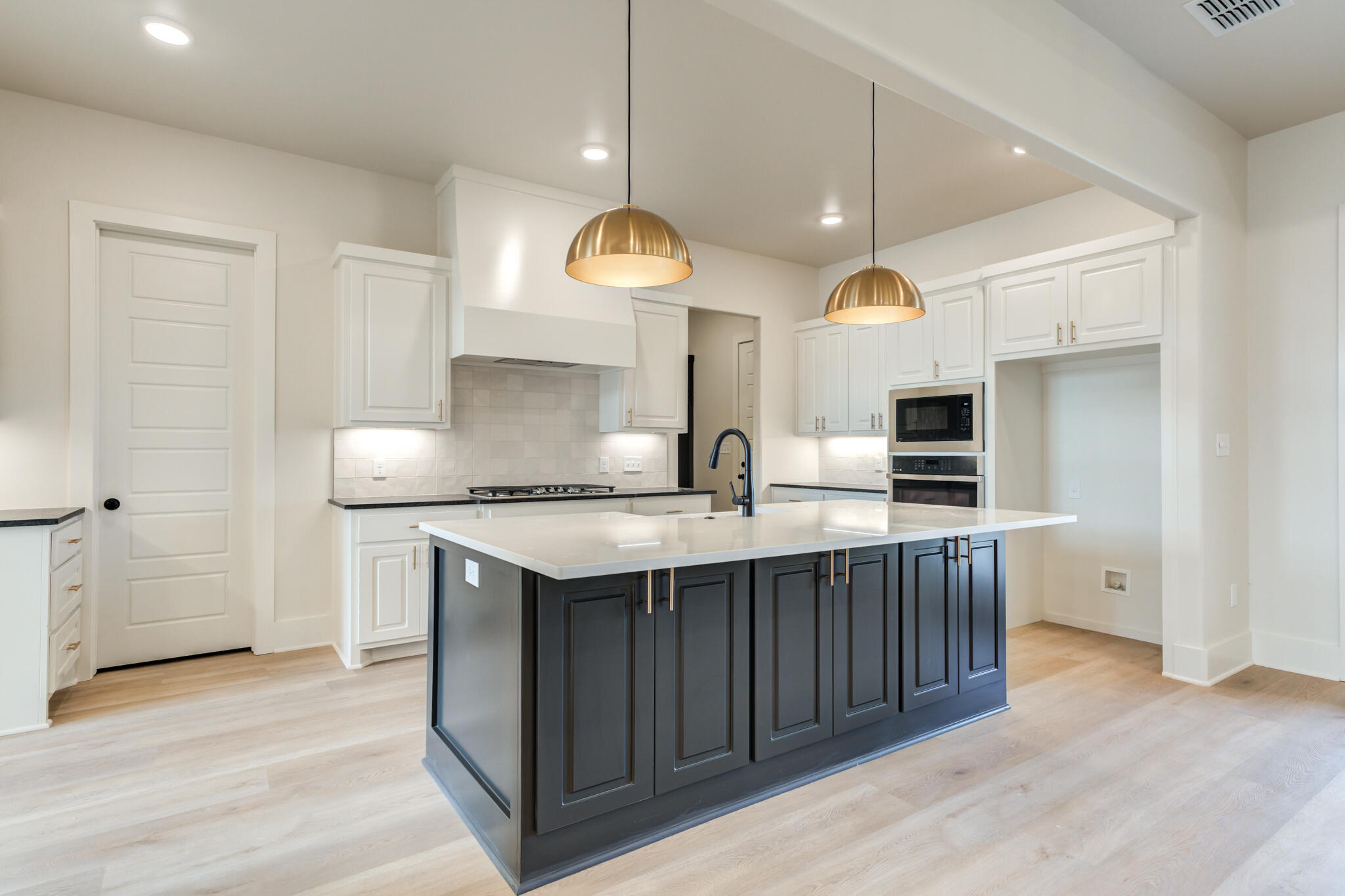 3516 141st Street Lubbock, TX 79423 - Photo 17 of 56 a kitchen with stainless steel appliances granite countertop a sink a stove and a wooden floors