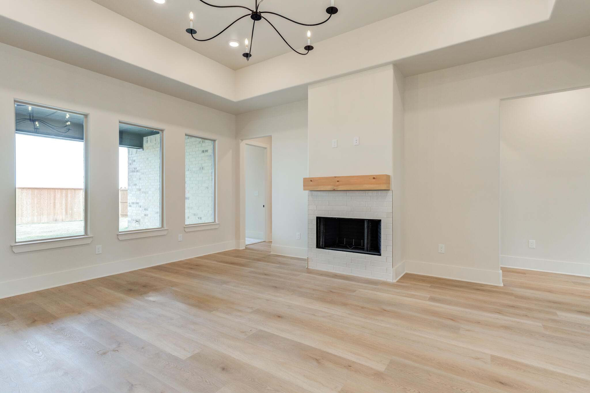 3516 141st Street Lubbock, TX 79423 - Photo 18 of 56 a view of an empty room with a window and fireplace
