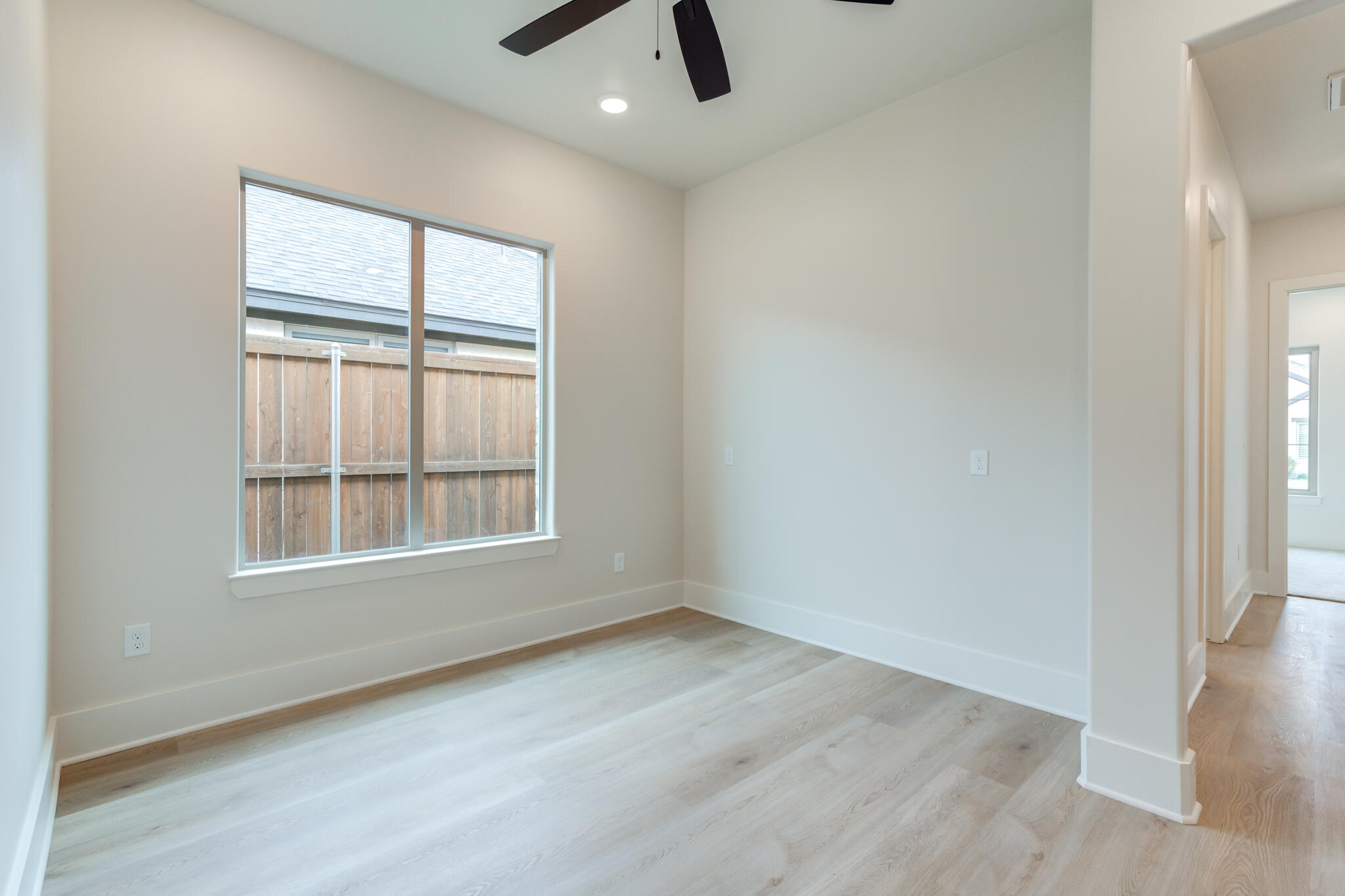 3516 141st Street Lubbock, TX 79423 - Photo 44 of 56 an empty room with chandelier fan and windows