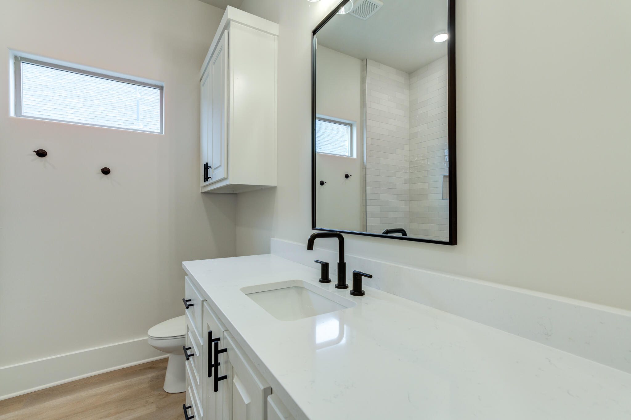 3516 141st Street Lubbock, TX 79423 - Photo 46 of 56 a bathroom with a sink a toilet and a mirror
