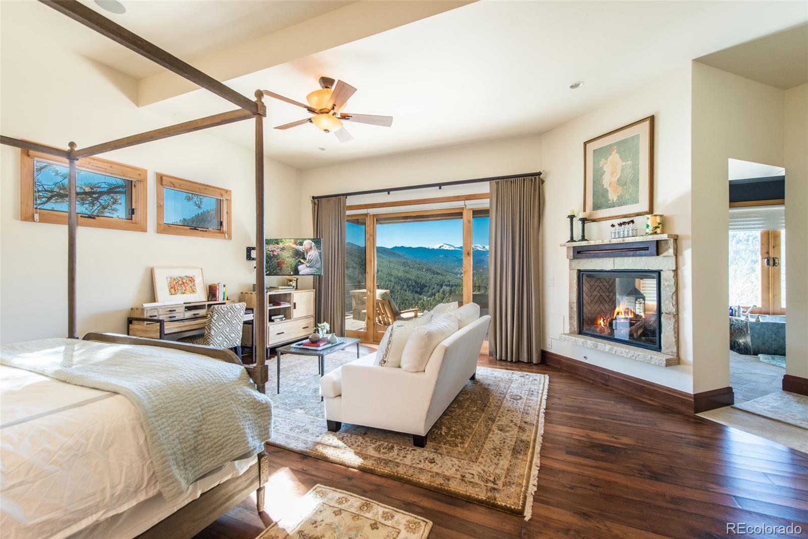 3731 Overlook Trail Evergreen, CO 80439 - Photo 14 of 35 a living room with furniture large window and wooden floor