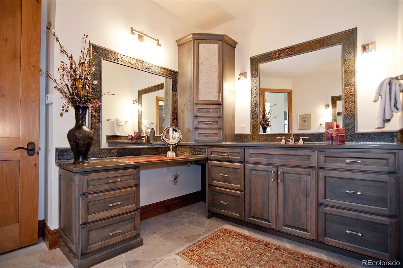 3731 Overlook Trail Evergreen, CO 80439 - Photo 18 of 35 a spacious bathroom with a granite countertop sink and a mirror