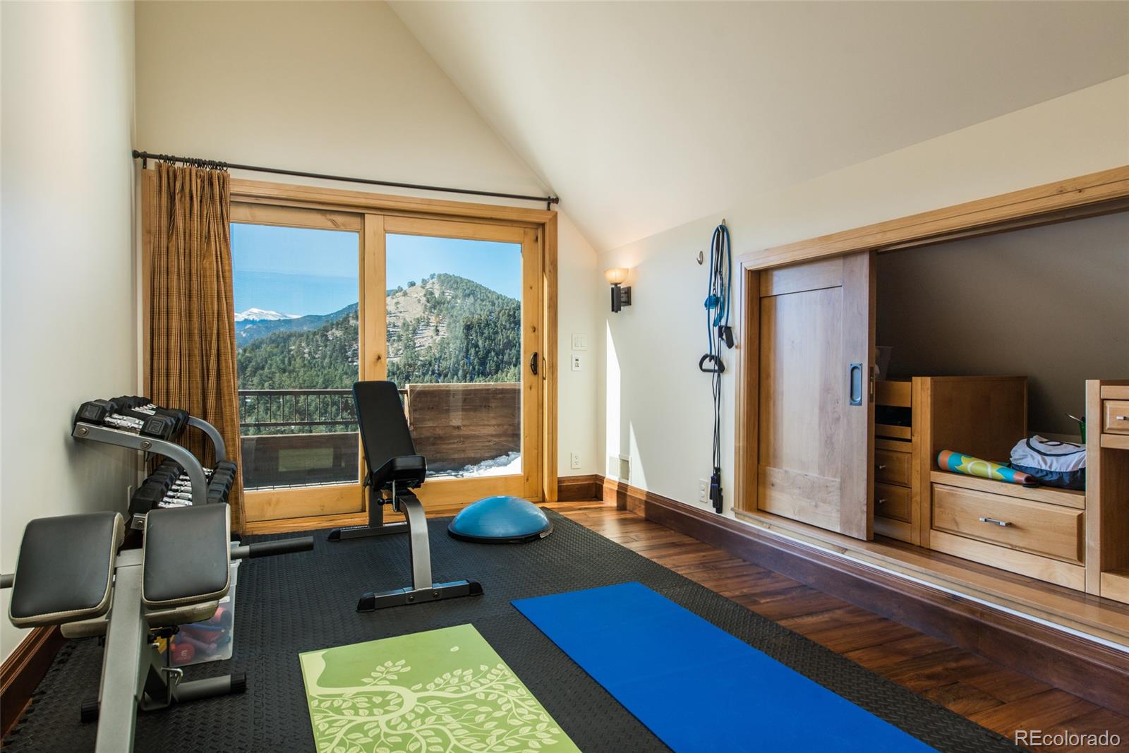 3731 Overlook Trail Evergreen, CO 80439 - Photo 28 of 35 a living room with furniture and a floor to ceiling window