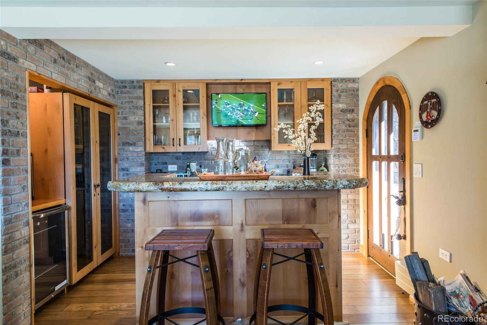 3731 Overlook Trail Evergreen, CO 80439 - Photo 30 of 35 a kitchen with stainless steel appliances granite countertop a refrigerator a stove and a sink with wooden floor