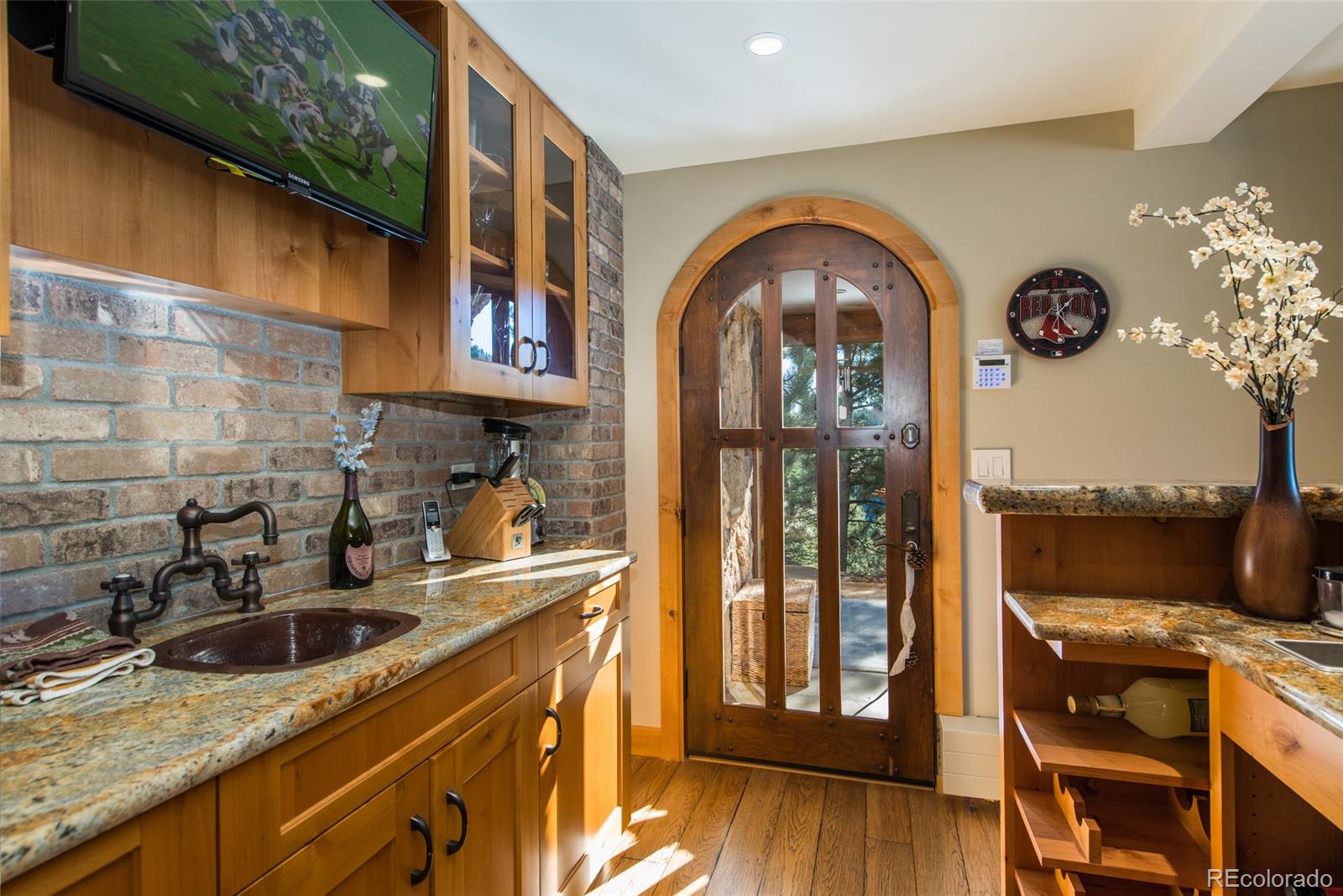 3731 Overlook Trail Evergreen, CO 80439 - Photo 31 of 35 a kitchen with a sink a stove and wooden floor