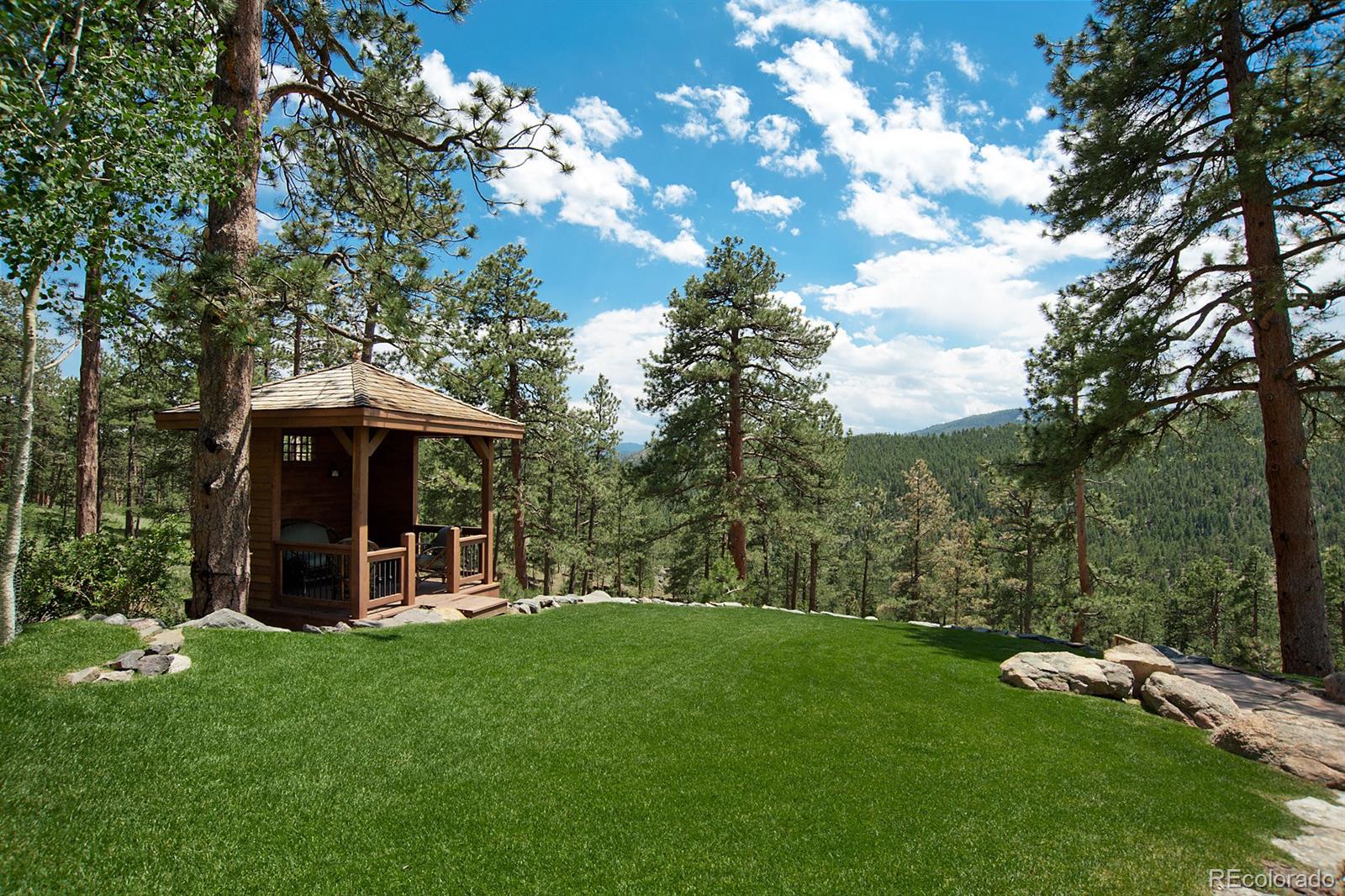 3731 Overlook Trail Evergreen, CO 80439 - Photo 34 of 35 a view of a chair and table in the garden