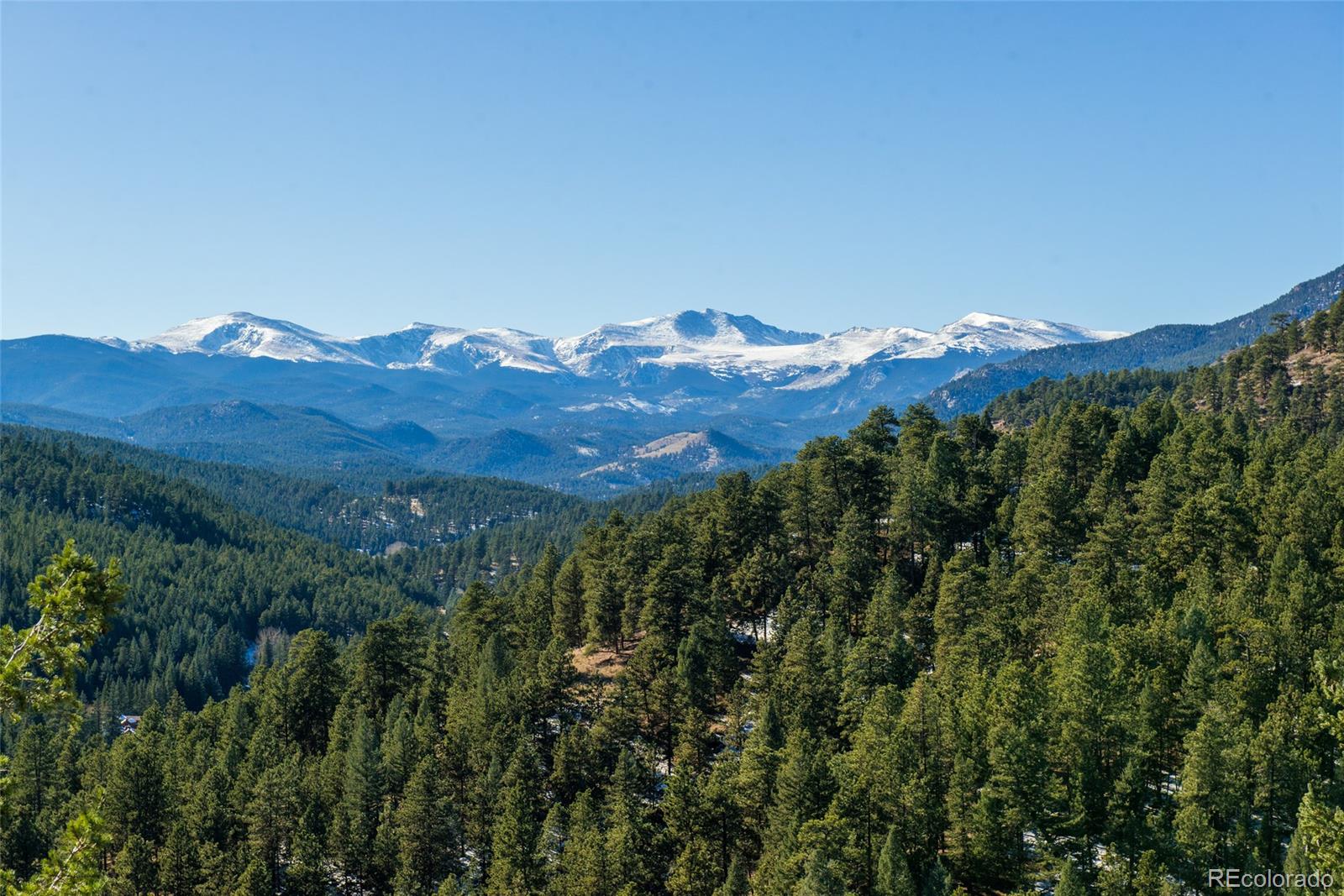 3731 Overlook Trail Evergreen, CO 80439 - Photo 4 of 35 a view of a large building with mountain view
