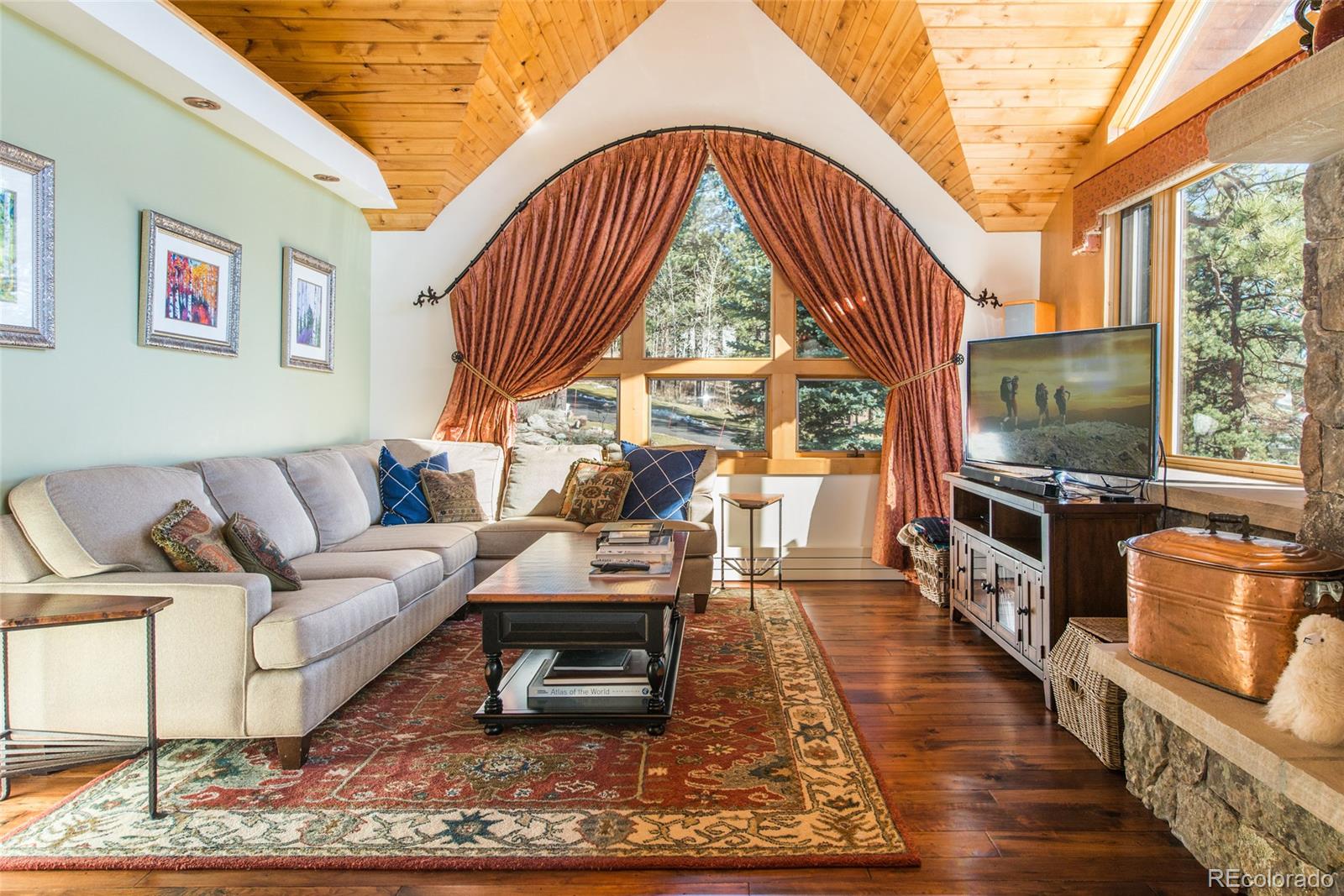 3731 Overlook Trail Evergreen, CO 80439 - Photo 6 of 35 a living room with furniture a rug wooden floor and a large window