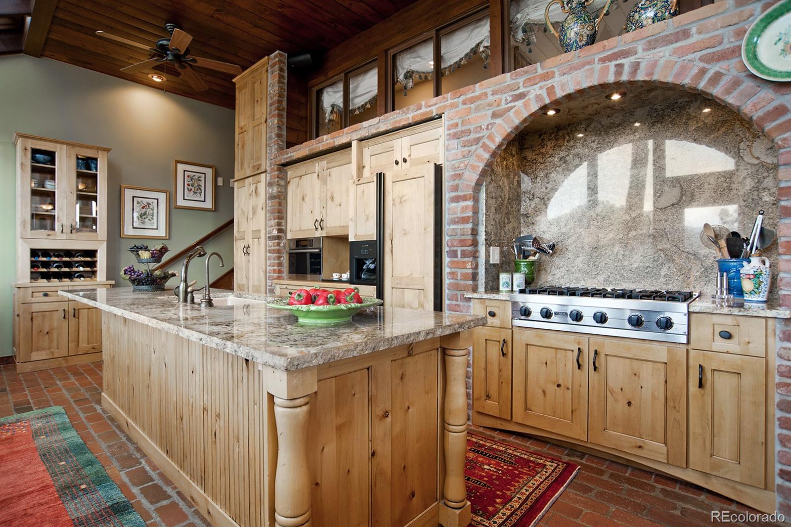 3731 Overlook Trail Evergreen, CO 80439 - Photo 7 of 35 a kitchen with kitchen island granite countertop a stove and white cabinets