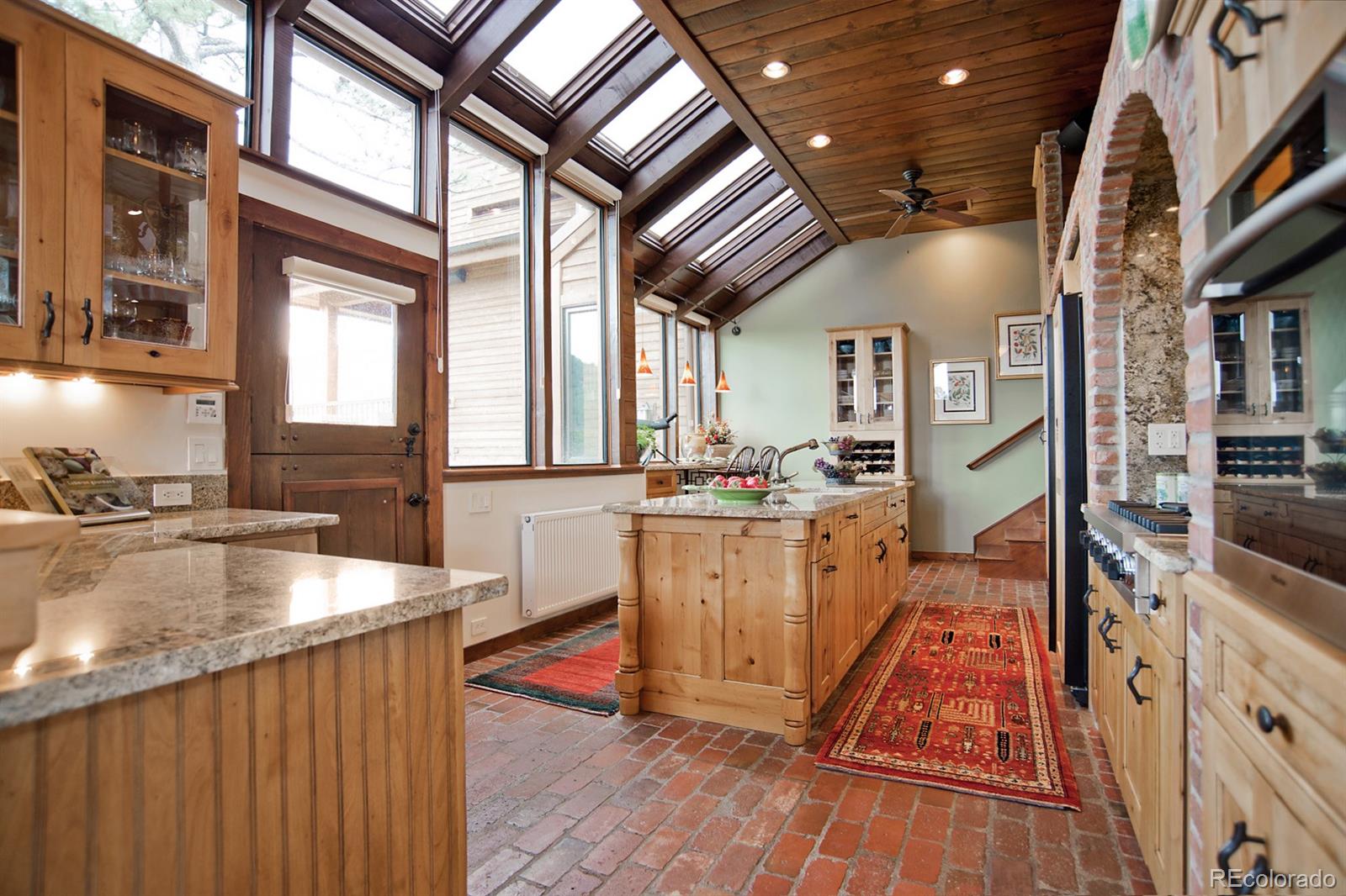 3731 Overlook Trail Evergreen, CO 80439 - Photo 8 of 35 a kitchen with counter top space and wooden floor