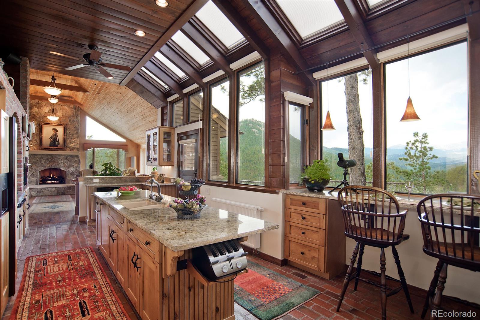 3731 Overlook Trail Evergreen, CO 80439 - Photo 10 of 35 a open kitchen with dining table and chairs