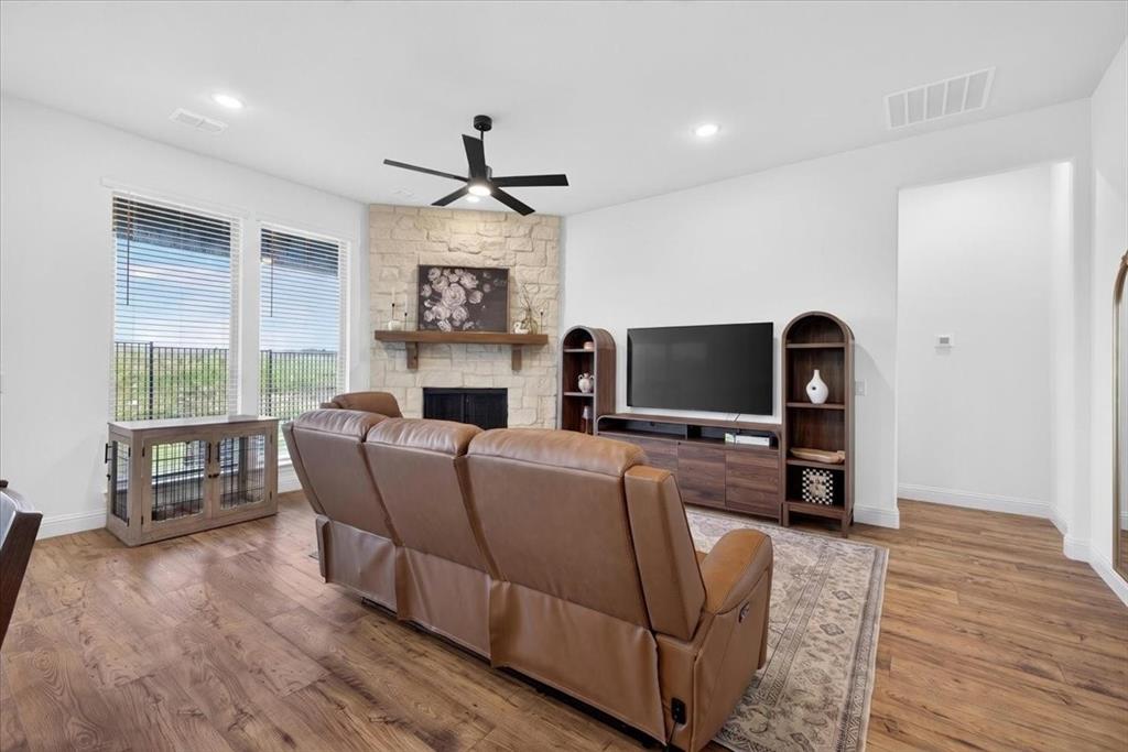 653 Godley Ranch Godley, TX 76044 - Photo 6 of 35 a living room with furniture a flat screen tv and a fireplace